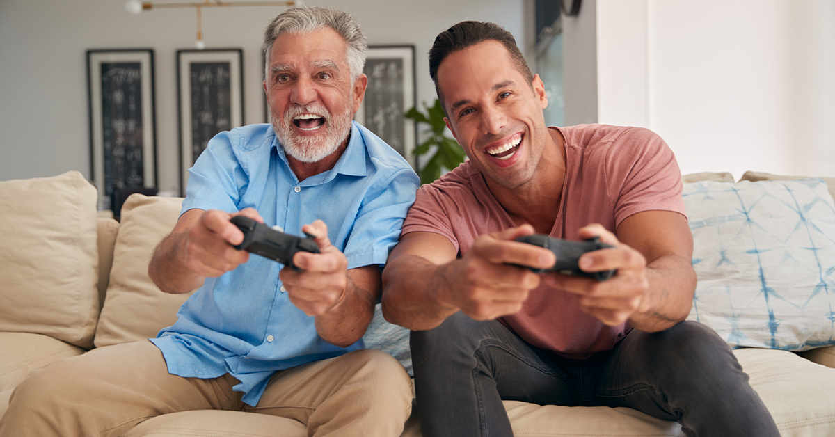 Adult Son and Dad Playing Games Console for Father's Day