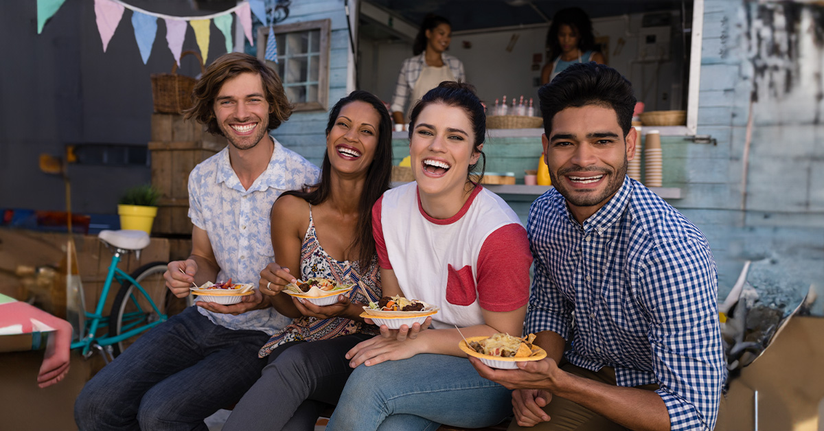 Image of People Eating on Picnic Bench