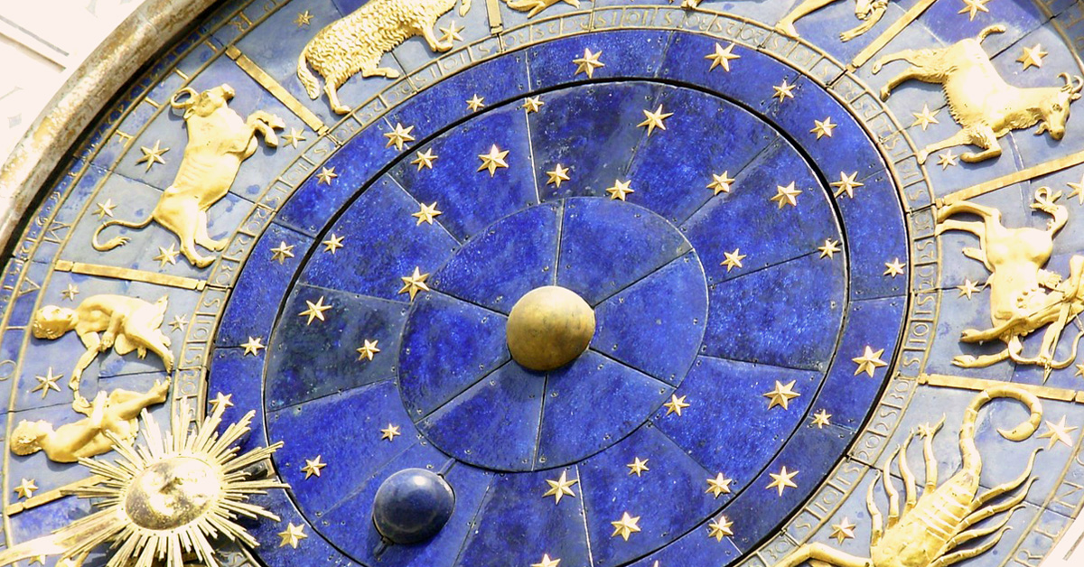 Blue clock with golden symbols of the star signs