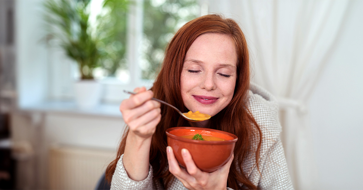 Woman enjoying bowl of soup